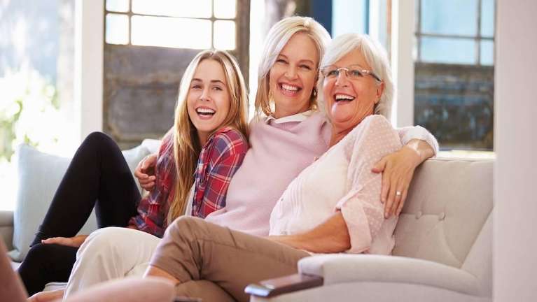 three generations of women sitting on couch | dentist las vegas nv