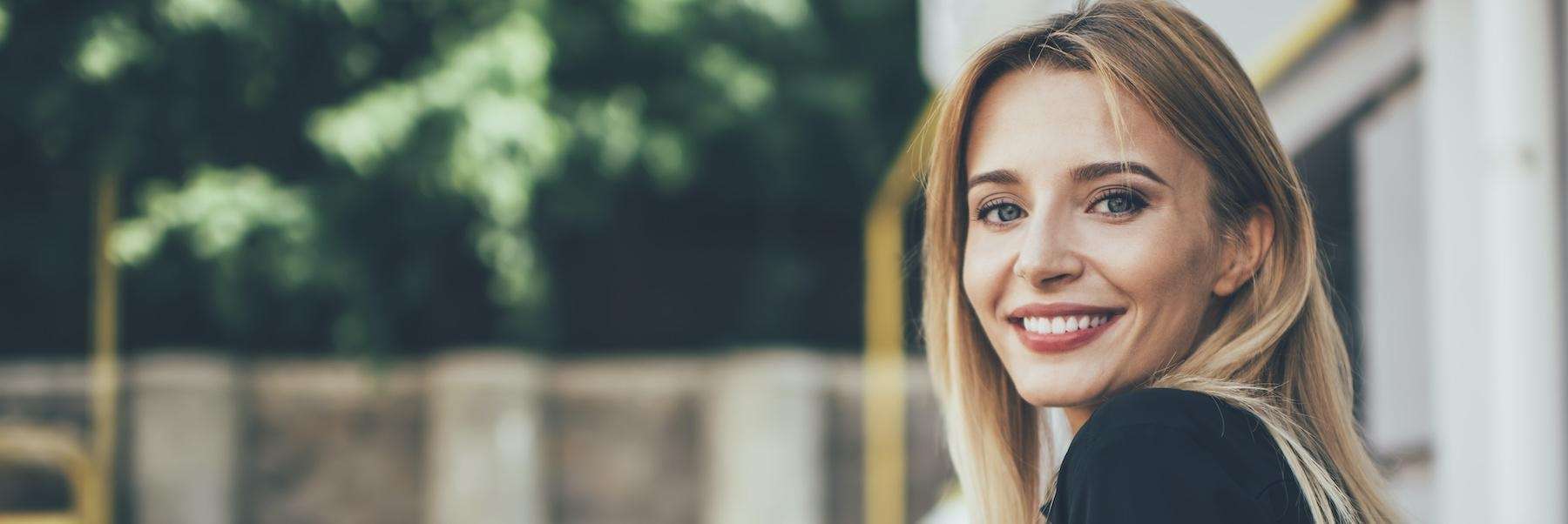 woman smiling after cosmetic dentist visit